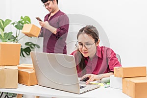 Asian man and woman checking product orders Before delivery, e-commerce, online selling and logistics Concept