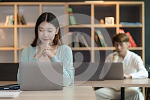 Asian man and woman meeting Asian Business Consultants to analyze and discuss financial report