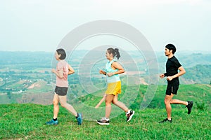 Asian man and woman trail runner running. On the high mountains, beautiful scenery. It`s a trail running practice. on a bright da