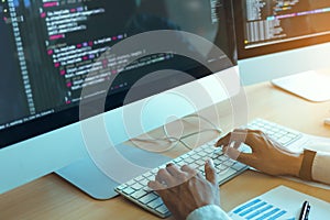 Asian man working code program developer computer web development working design software on desk in office