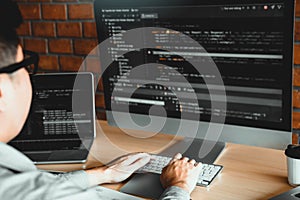 Asian man working code program developer computer web development working design software on desk in office