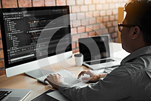 Asian man working code program developer computer web development working design software on desk in office