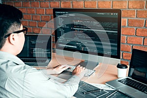 Asian man working code program developer computer web development working design software on desk in office