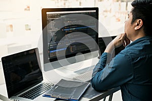 Asian man working code program developer computer web development working design software on desk in office