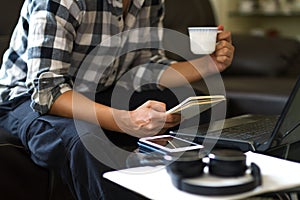 Asian man working from home while enjoy with a cup of coffee