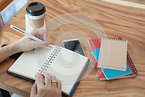 Asian man writing text on notebook