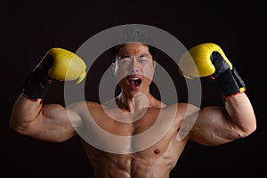 Asian Man with yellow boxing gloves posing