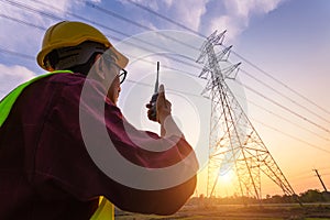 Asian Manager Engineering in standard safety uniform working inspect the electricity high voltage pole