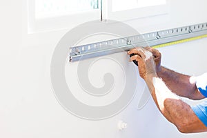 Asian Mans Measuring A Wall With Measure Tape Preparing To Build