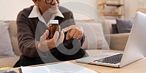 Asian Mature adult man having video call consulting with doctor medicine on laptop from home, telehealth or telemedicine