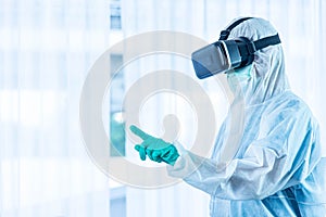 ASIAN medical staff wear PPE suit and medical glove with VR glasse touching the air to monitor patient health