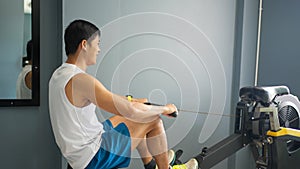 Asian men athlete doing situps exercise with machine to strengthen muscle for health care at gym stadium