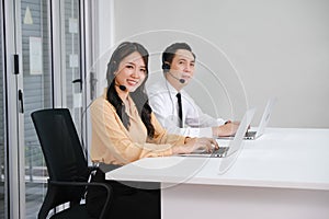 asia man and beautiful asian woman working call center operator with headset in office or workplace