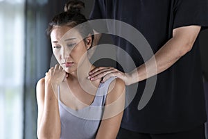 Asian man consoling the depressed woman. Husband trying to comfort his wife at home