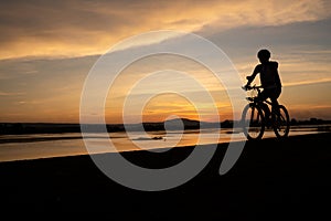 Asian men cycling bicycle on the road in the sunset