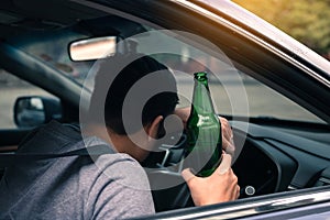 Asian men drink a lot of alcohol until and unconscious his can`t drive home and decide to sleep at the steering wheel