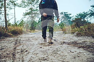 Asian men travel photograph nature. Travel relax. Walk on the path. Nature Study in the Jungle. Thailand