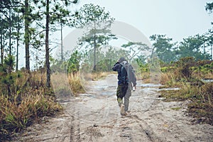 Asian men travel photograph nature. Travel relax. Walk on the path. Nature Study in the Jungle. Thailand