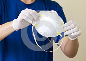 Asian Men Wear Medical Gloves And Hold Medical Masks N95. In Order to Campaign to Wear to Prevent the Corona Virus that is Spreadi