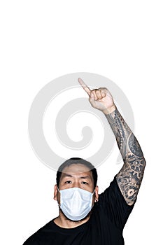 Asian men is wear a medical mask and showing a hand with point sign in white background with copy space above.The concept of