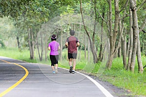 Asian middle aged couple jogging and running in park