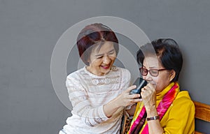 Asian middle aged daugther takecare senior mother at home