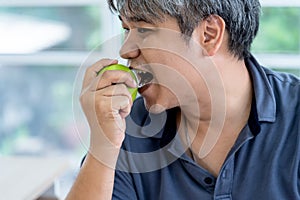 men Eating fruit Which is green apple