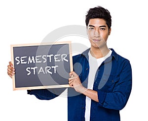 Asian mixed Indian man with blackboard showing phrases of semest