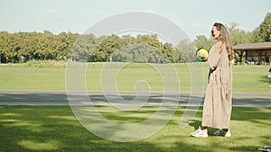 Asian mom and Caucasian daughter play ball, nature, park, summer, vacation, sunglasses