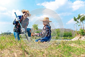 Asian mom and child girl plants sapling tree in the nature spring for reduce global warming growth feature and take care nature ea