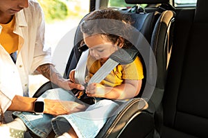 Asian Mom Sitting Down Toddler In Baby Car Seat Inside