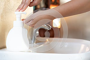 Asian Mom women wash her kid hand with soap alcohol gel for sanitizer in kitchen sink concept for prevent Hygiene health care.