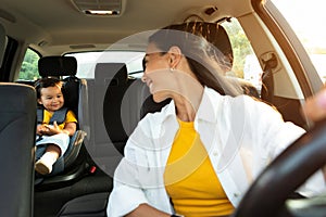 Asian Mommy And Toddler In Baby Car Seat Inside Automobile