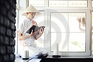 Asian monk reading an old book