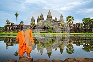 Asian  monk stand and look to Angkor wat in siem reap