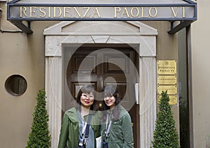 Asian Mother and Amerasian teenage daughter in front of the Residenza Paolo VI