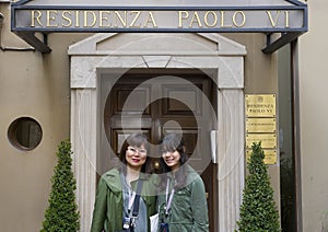 Asian Mother and Amerasian teenage daughter in front of the Residenza Paolo VI photo
