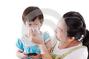 Asian mother carrying and blowing nose her daughter on white background