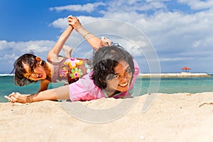 Asian mother and child fun play at the beach