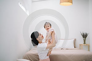 Asian mother and child relaxing on the bed room