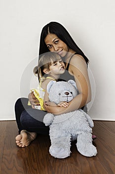 Asian mother cuddling her 3-year-old daughter