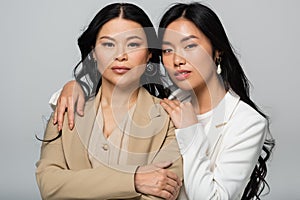 asian mother and daughter embracing isolated
