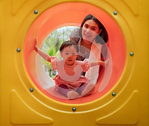 Asian mother and daughter are happiness and enjoy together in playground, with fully happiness moment