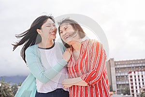 Asian mother and daughter having fun outdoor - Happy family people enjoying time togehter around city in Asia - Love, parenthood