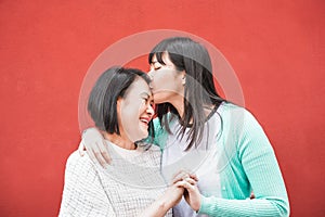 Asian mother and daughter having fun outdoor - Happy family people enjoying time togehter - Love, parenthood lifestyle, tender