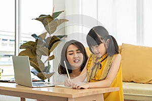 Asian mother and daughter kid using smartphone at home