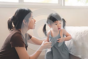 Asian mother disciplining her child, Asian girl kid being defiant with mom, Terrible two concept