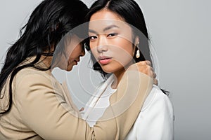 asian mother embracing young daughter 