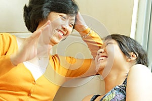 Asian mother happy talking with teen daughter