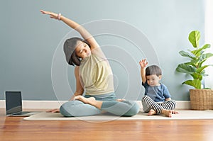 Asian Mother and her little son exercising at home together